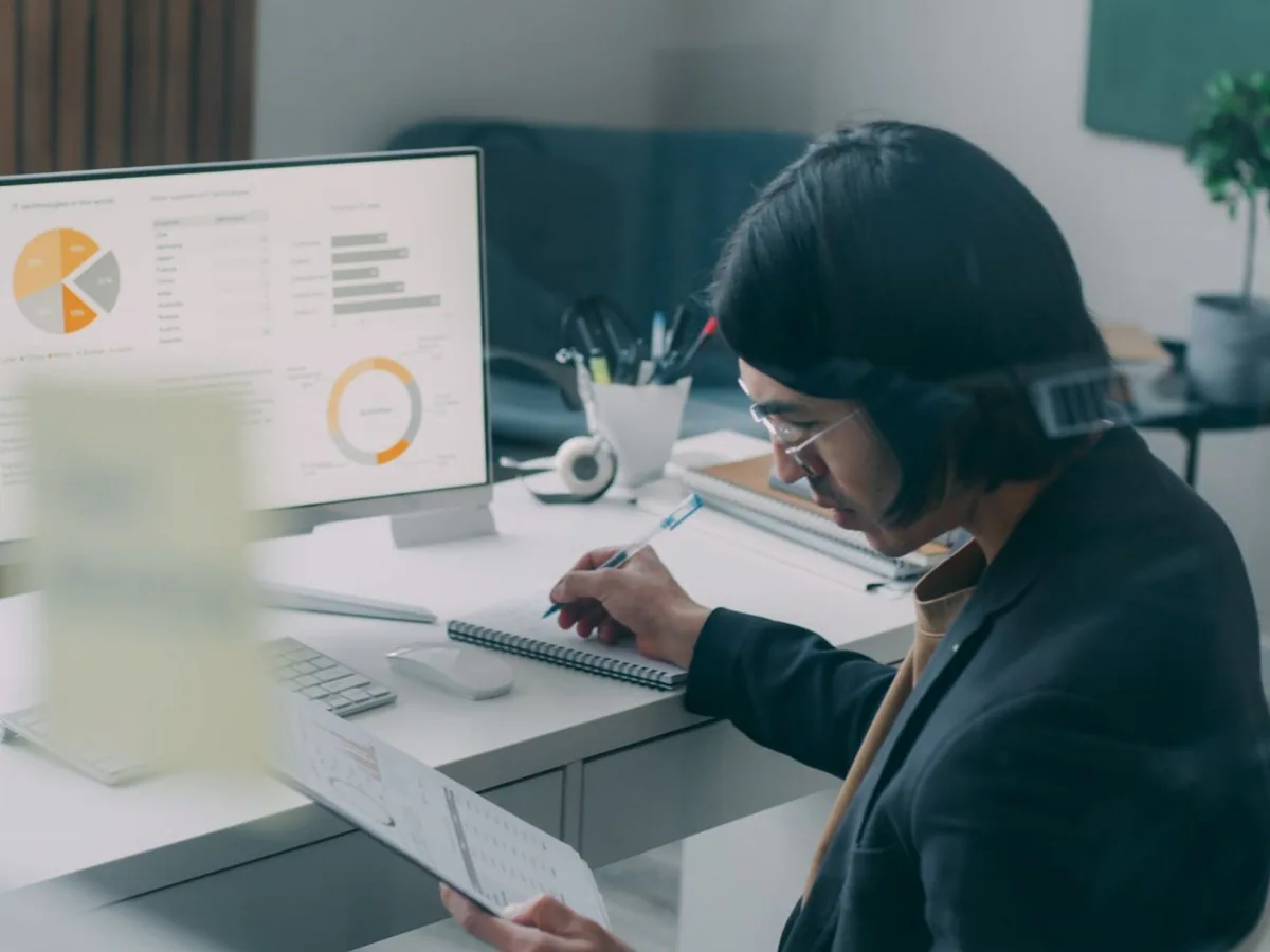 Professional examining charts at an office workstation