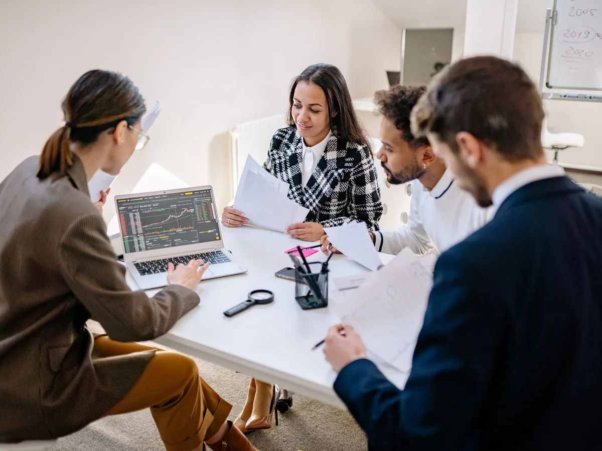 Professionals reviewing a laptop together during a planning meeting