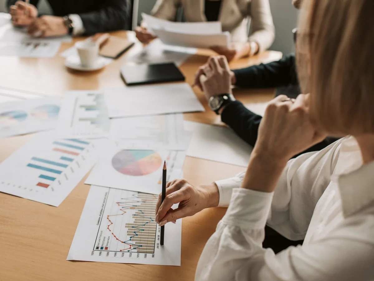People reviewing business reports together at a desk