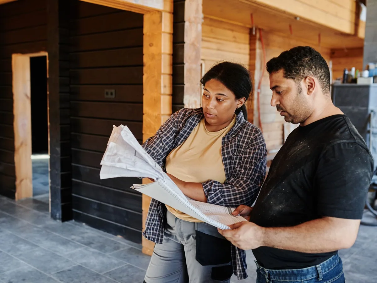 Construction professionals reviewing plans inside a building