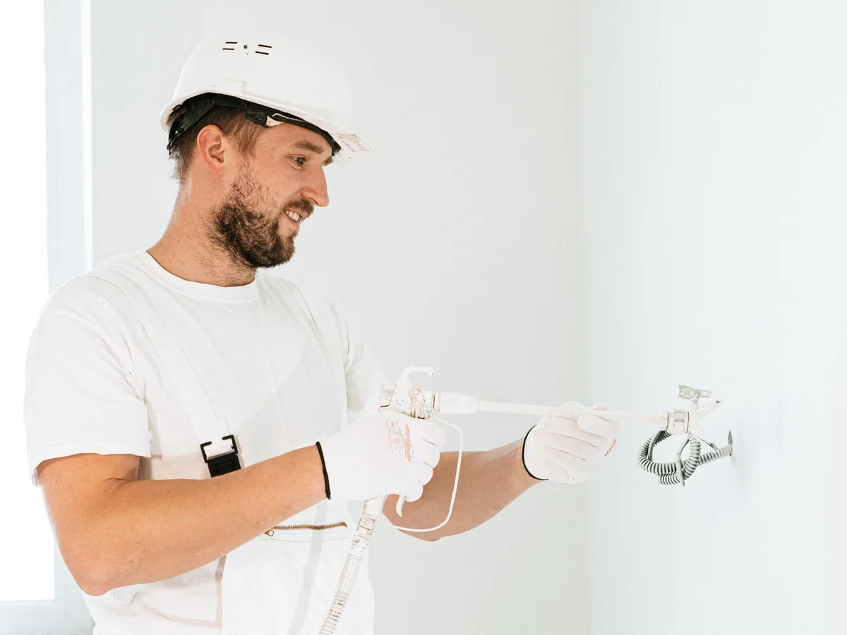Electrician in safety equipment installing wiring