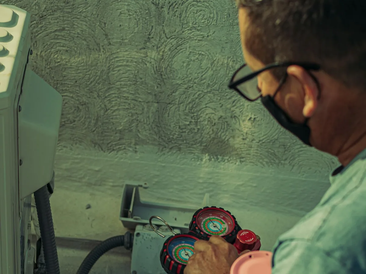Technician checking an outdoor air-conditioning system