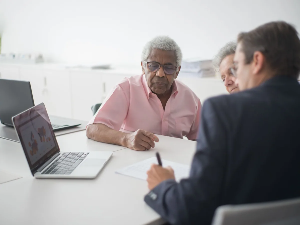 Consultant discussing paperwork with a couple