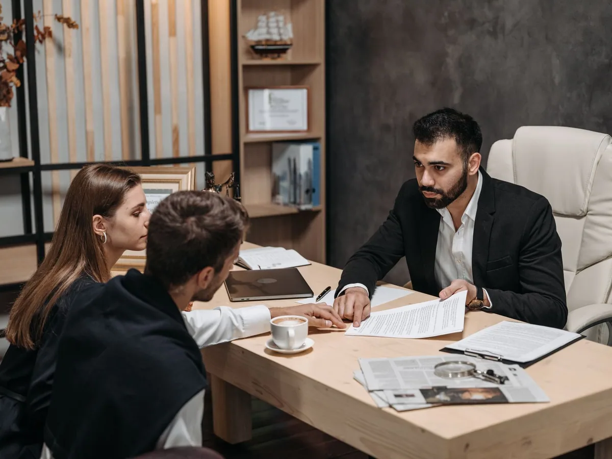 Legal professional discussing documents in an office