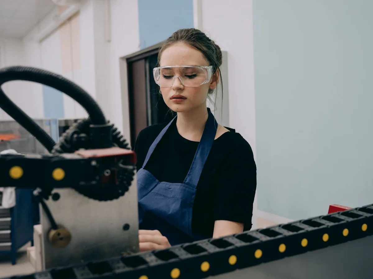 Manufacturing professional operating equipment while wearing safety glasses