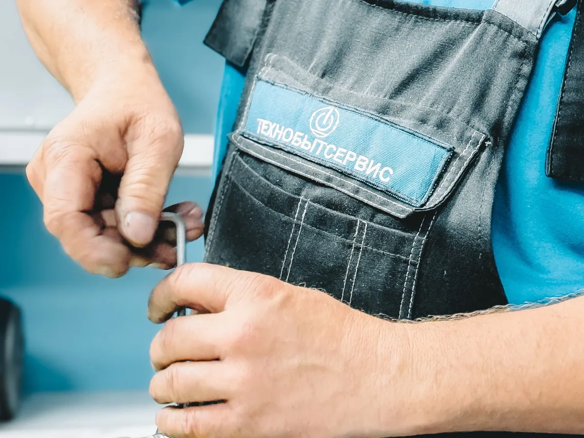 Plumber using a wrench to repair pipework