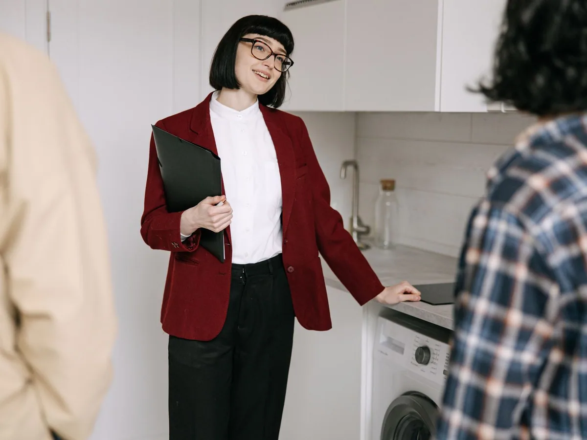 Estate agent showing an apartment to prospective buyers