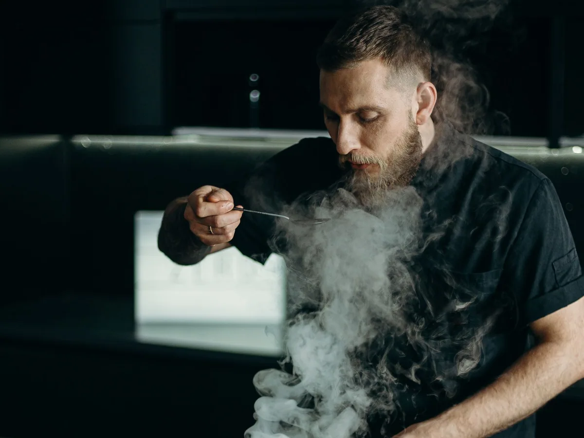 Chef tasting a dish while cooking in a restaurant kitchen