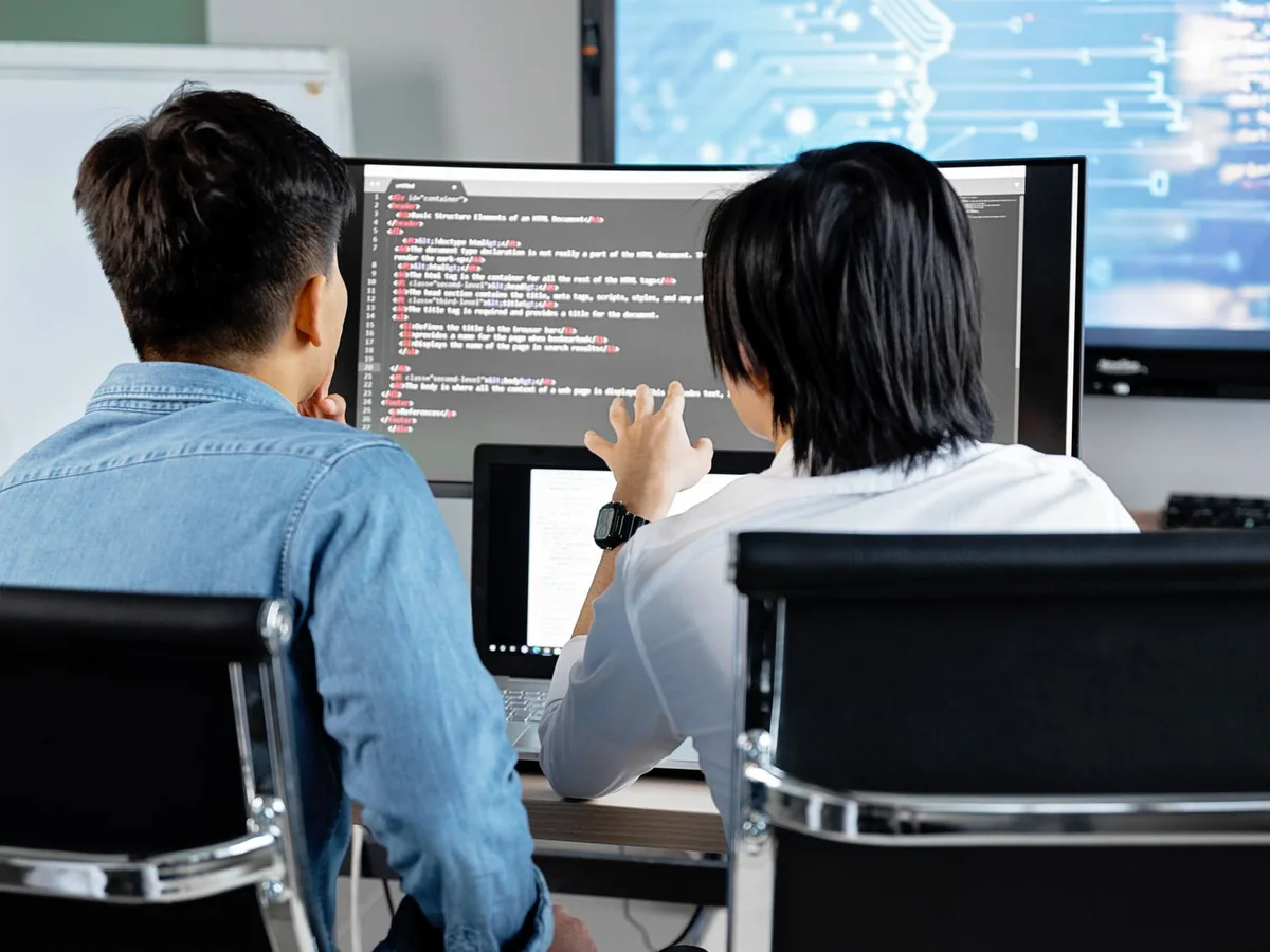 Software developers collaborating at a computer